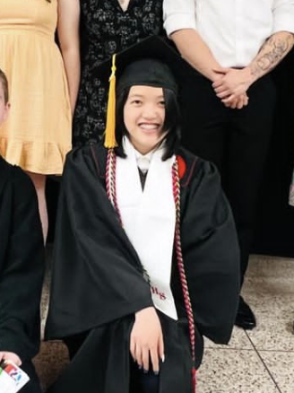 Cropped image of Finley wearing graduation cap and gown