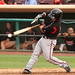 A big major leaguer swinging his bat hitting a baseball hard